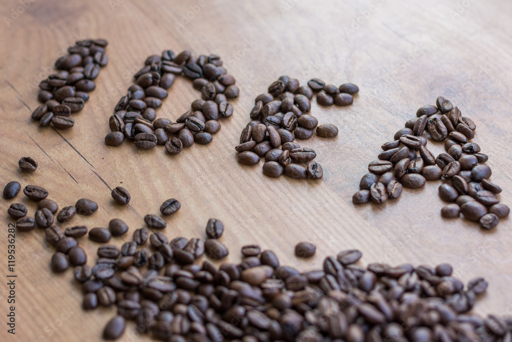 Conceptional sign IDEA drawn among brown roasted coffee beans Conceptional sign IDEA drawn among brown roasted coffee beans