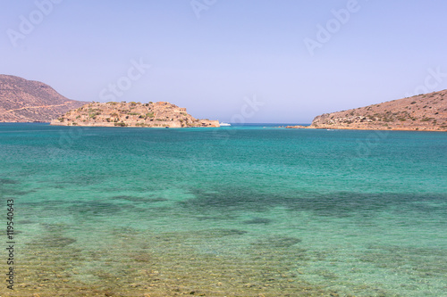 The sea of different colors of blue surrounded by mountains