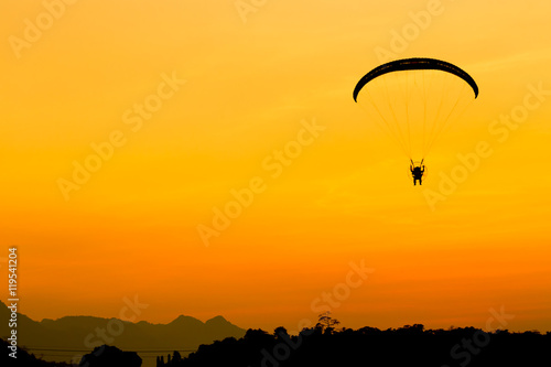 Glider, Paramotor flying with orange twilight sky
