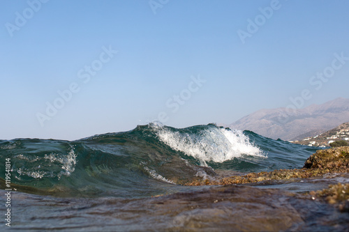 Sea Wave and foam on a background of mountains