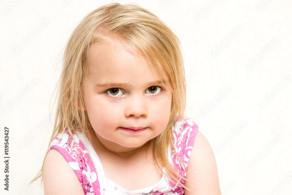 Closeup Headshot Portrait of Beautiful Toddler Girl with Mischevious Expression Closeup Headshot Portrait of Beautiful Toddler Girl with Mischevious Expression