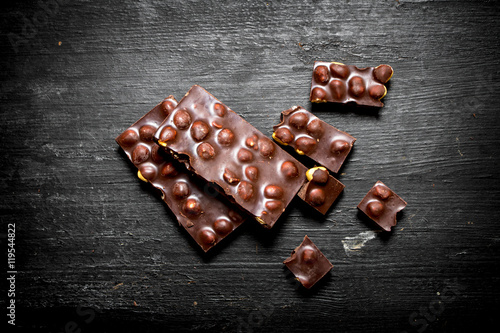 The chunks of chocolate with whole hazelnuts .