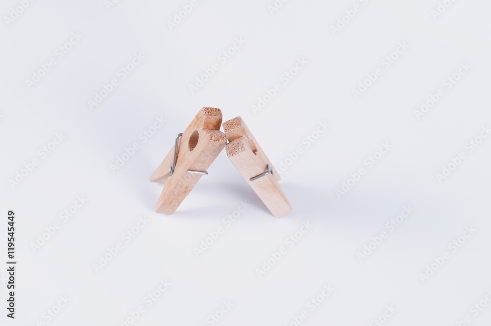Pair of wooden cloth pegs on white background. Pair of wooden cloth pegs on white background.