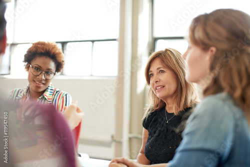 Unposed group of creative business people in an open concept office brainstorming their next project.