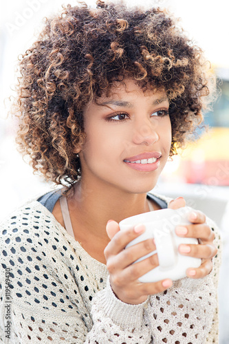 Young african american woman drinking coffee.