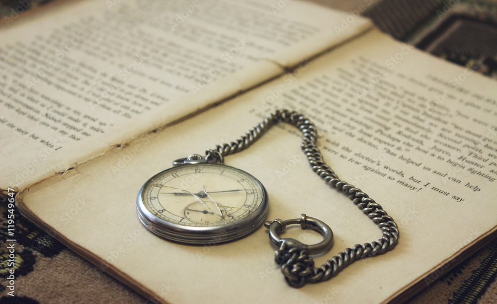Old pocket watch on the book Old pocket watch on the book