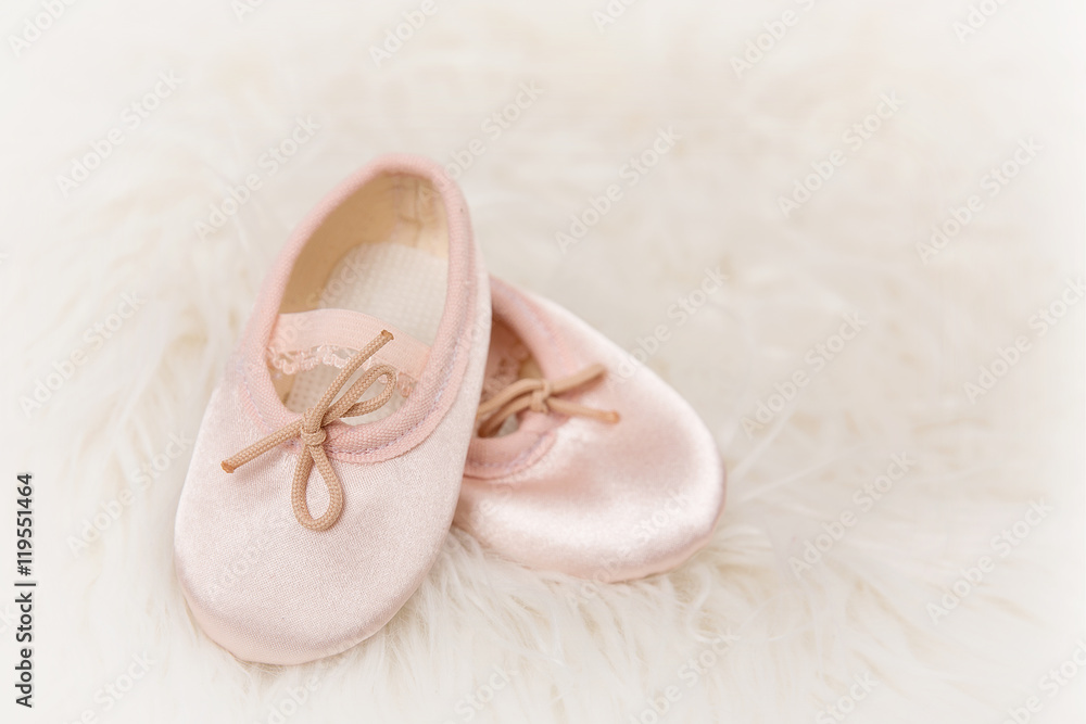 Fototapeta premium Light pink ballet dance shoes on a white fluffy background