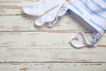 Baby clothes on wooden background