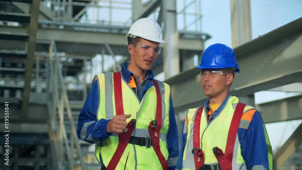 Industrial engineer and worker discussing in factory Industrial engineer and worker discussing in factory