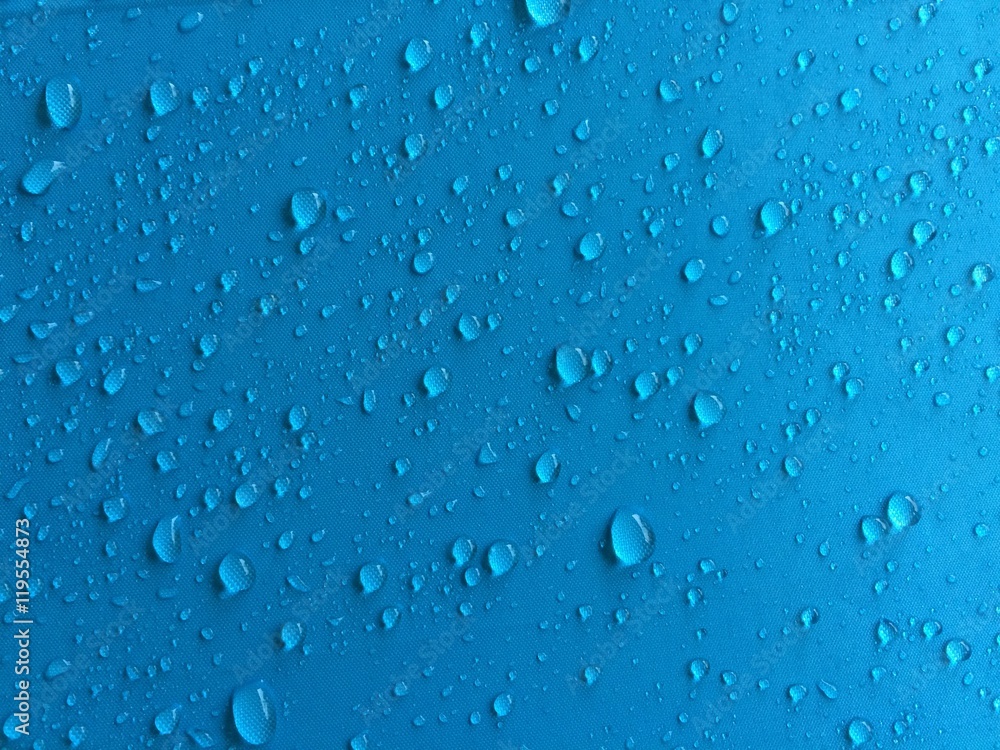 Rain drops on blue shade umbrella background. Mobile photography