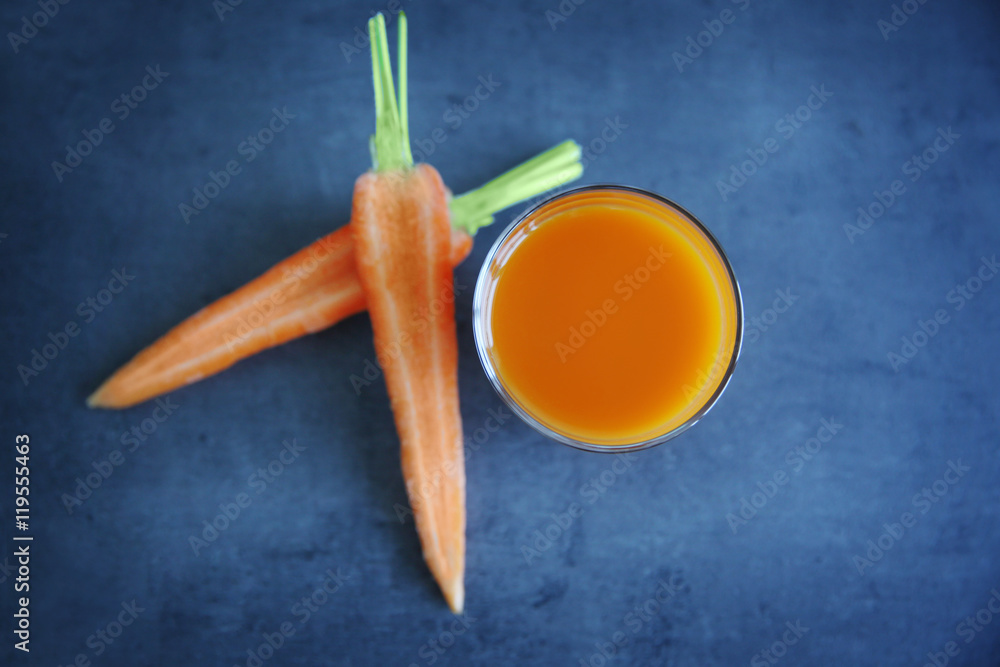 Fresh carrot juice in glass on table Fresh carrot juice in glass on table