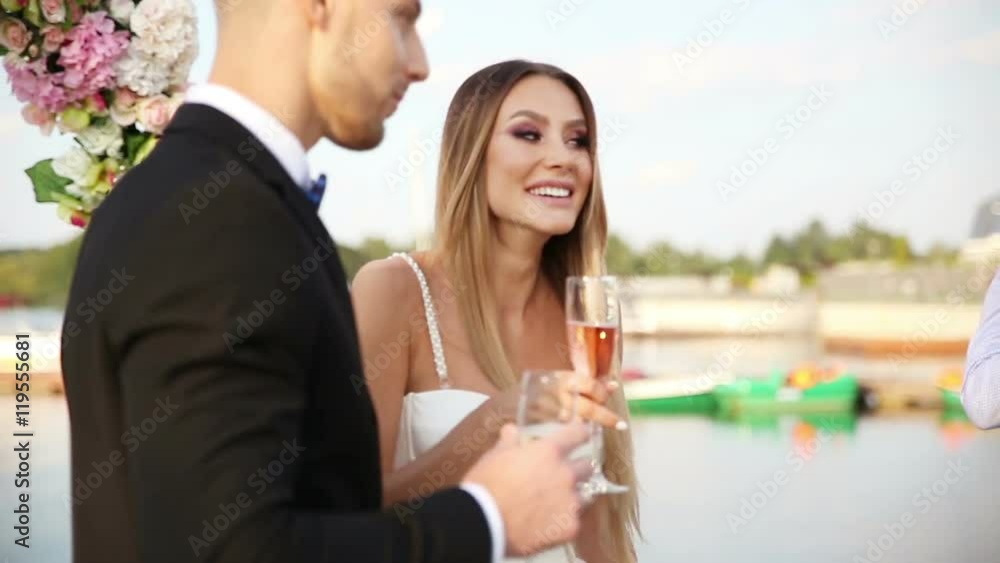 Bride and groom enjoying champagne on their wedding celebration Bride and groom enjoying champagne on their wedding celebration