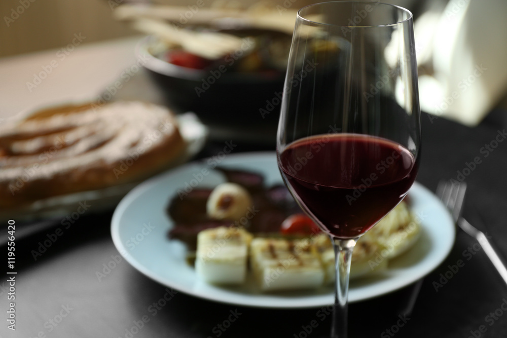 Glass of wine and grilled vegetables on served table Glass of wine and grilled vegetables on served table