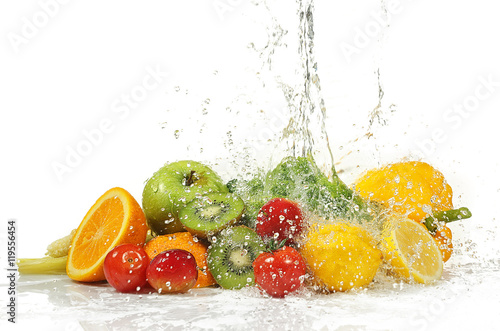 Vegetables and fruits with  splashing water on white background
