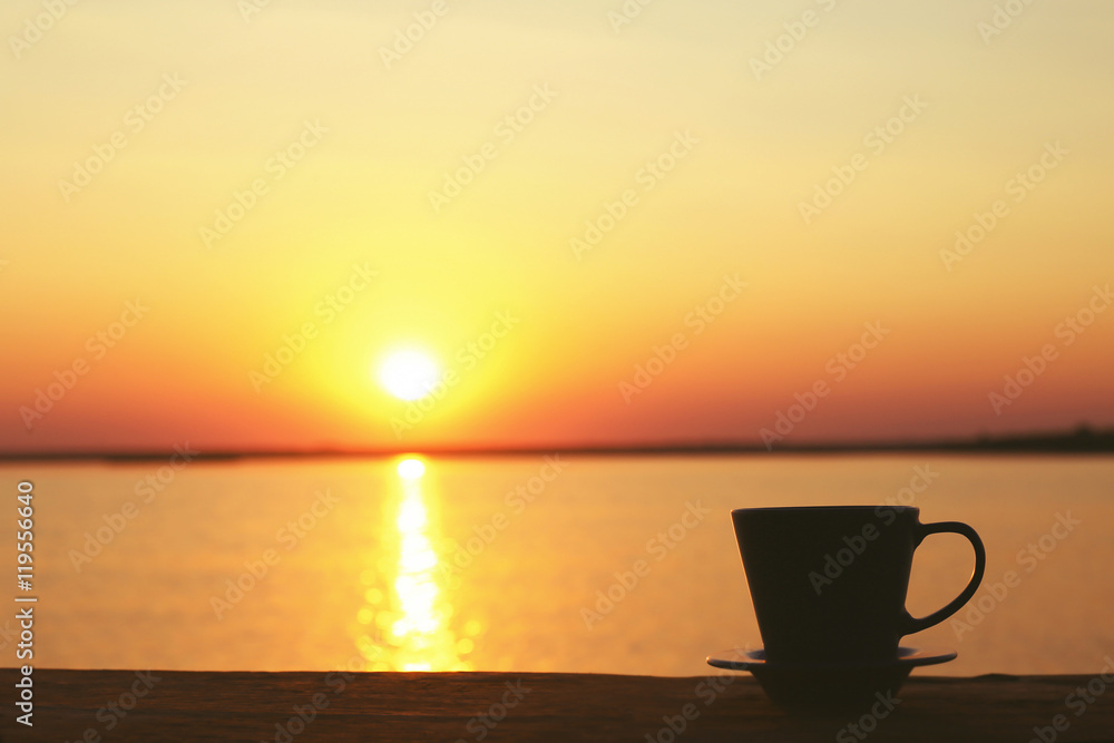 Cup of coffee on sunset background Cup of coffee on sunset background