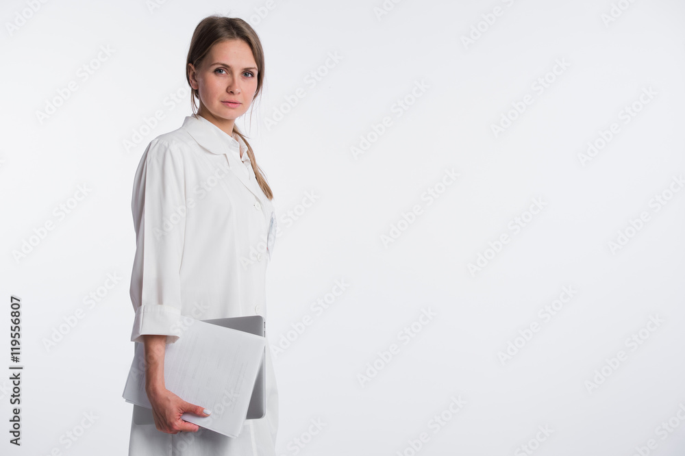 Woman doctor with papers and laptop isolated on the white. Place for copy space. Woman doctor with papers and laptop isolated on the white. Place for copy space.