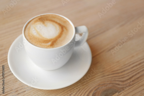 Cup of fresh coffee on wooden table