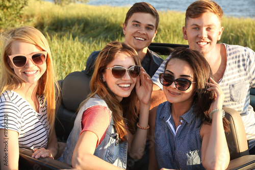 Happy friends in car