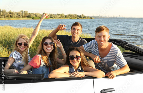 Happy friends in car