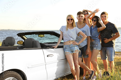 Happy friends near car