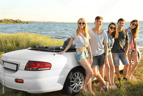 Happy friends near car