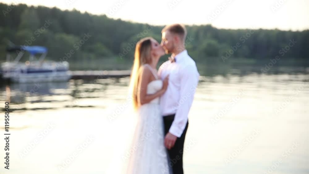 loving newlyweds hugging on the seaside promenade loving newlyweds hugging on the seaside promenade