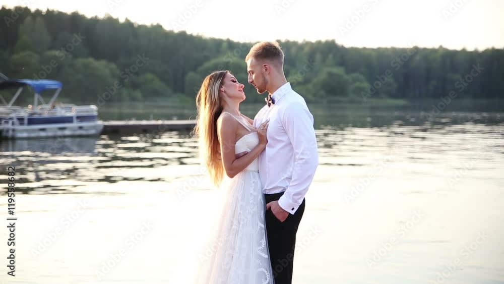 loving newlyweds hugging on the seaside promenade loving newlyweds hugging on the seaside promenade