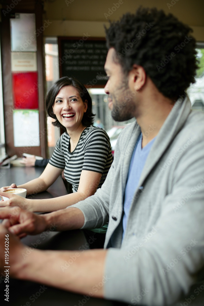 Happy woman talking to man in cafe Happy woman talking to man in cafe