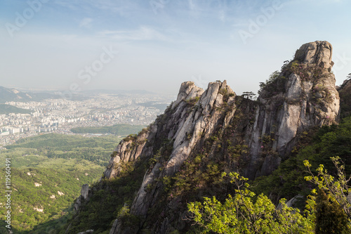 View of the city from above and steep granite peaks of Jaunbong Peak on Dobongsan Mountain at the Bukhansan National Park in Seoul  South Korea.