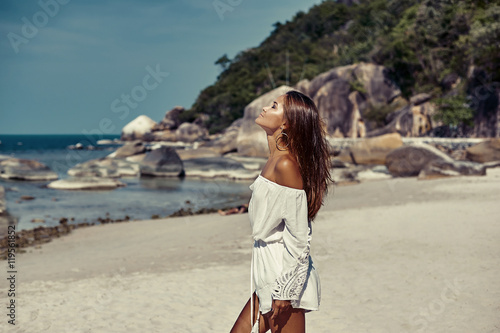 Beautiful woman enjoying freedom on a tropical beach