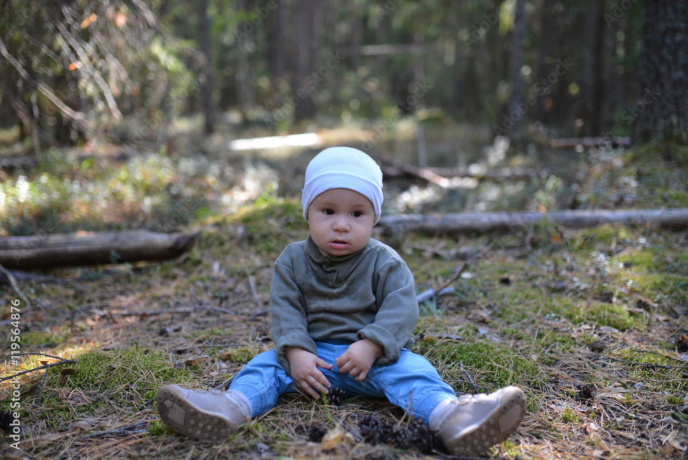 sad boy lost in forest sitting on the ground alone sad boy lost in forest sitting on the ground alone