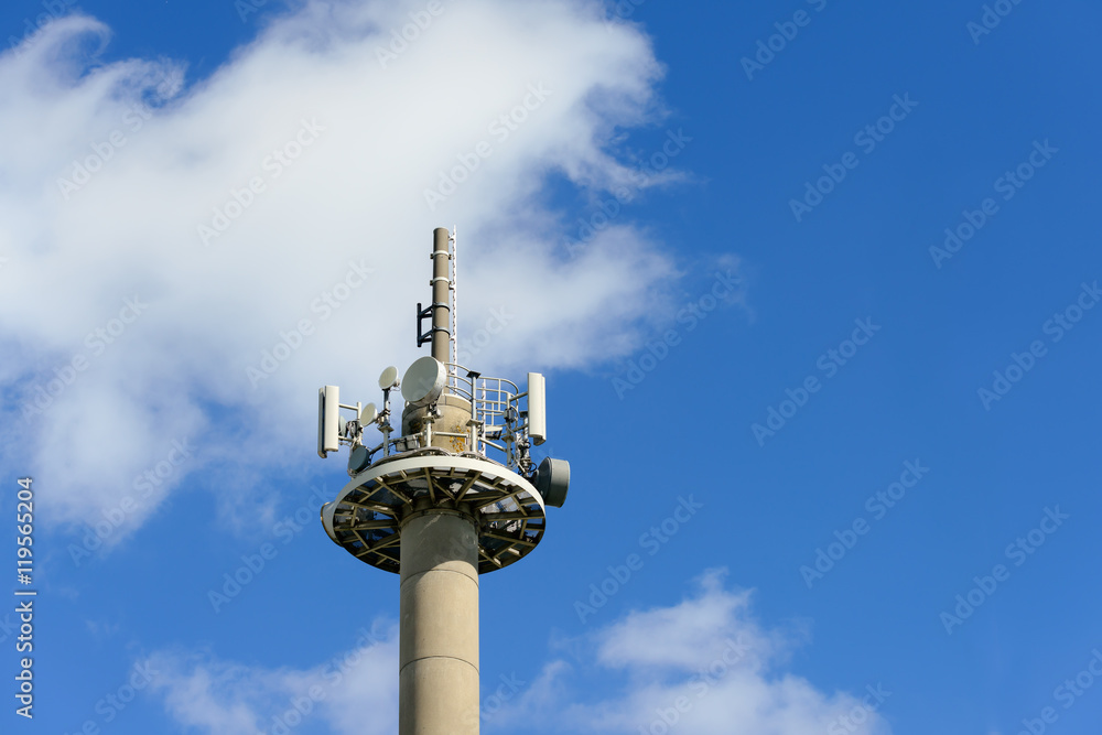 Telecommunication tower with cellphone mobilephone transmitters.against the blue sky.