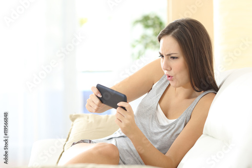 Girl playing games on line in smart phone