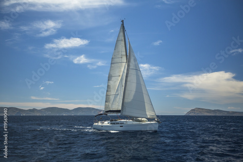 Sailing ship luxury yacht with white sails in the Aegean Sea.