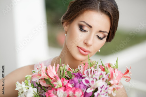 Beautiful woman with flowers outdoors