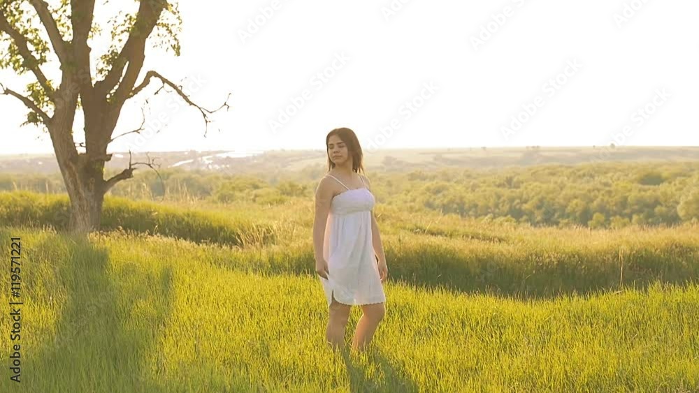 on a green meadow the girl dressed in slow motion video on a green meadow the girl dressed in slow motion video