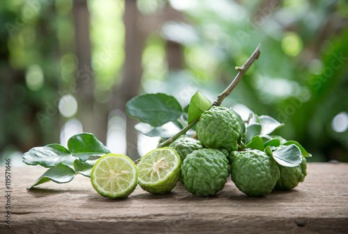 Kaffir lime with leaves on wooden background.