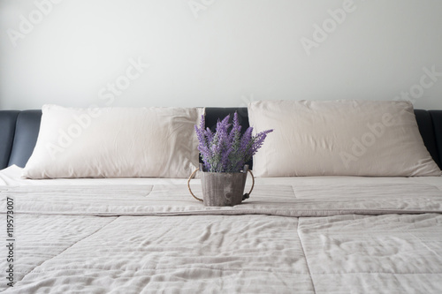 The bed with purple lavender flower on flower pot. photo