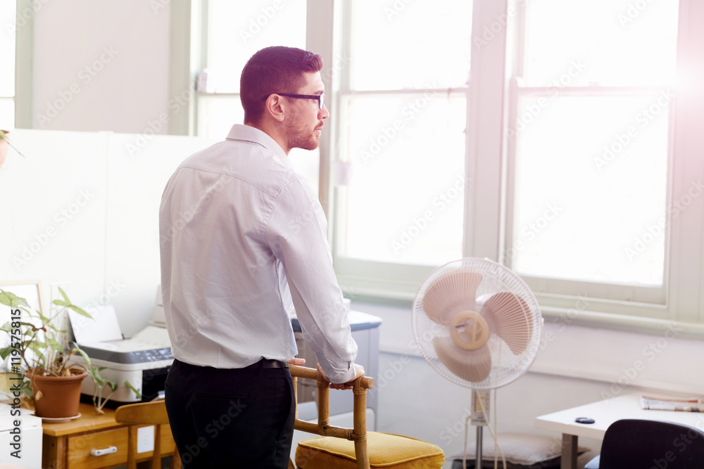 Portrait of young man sitting at the stairs in office Portrait of young man sitting at the stairs in office