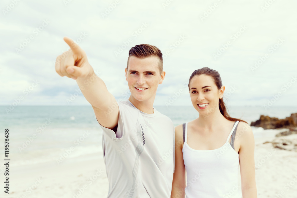 Couple of runners standing together on beach Couple of runners standing together on beach