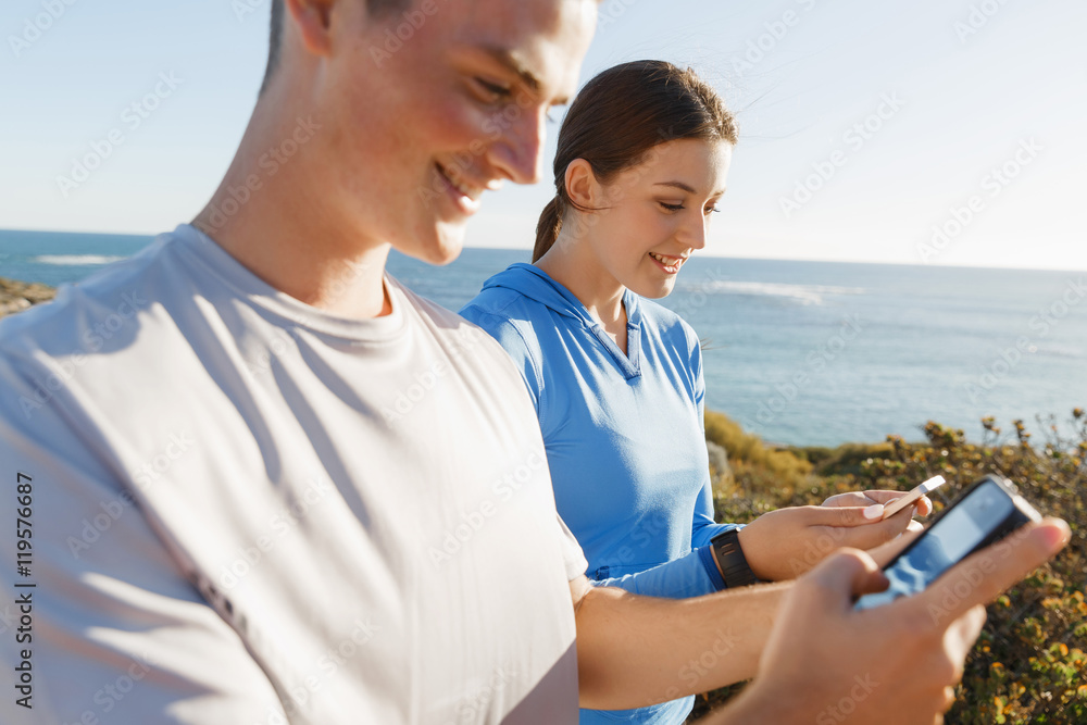 Young couple with smartphones outdoors Young couple with smartphones outdoors