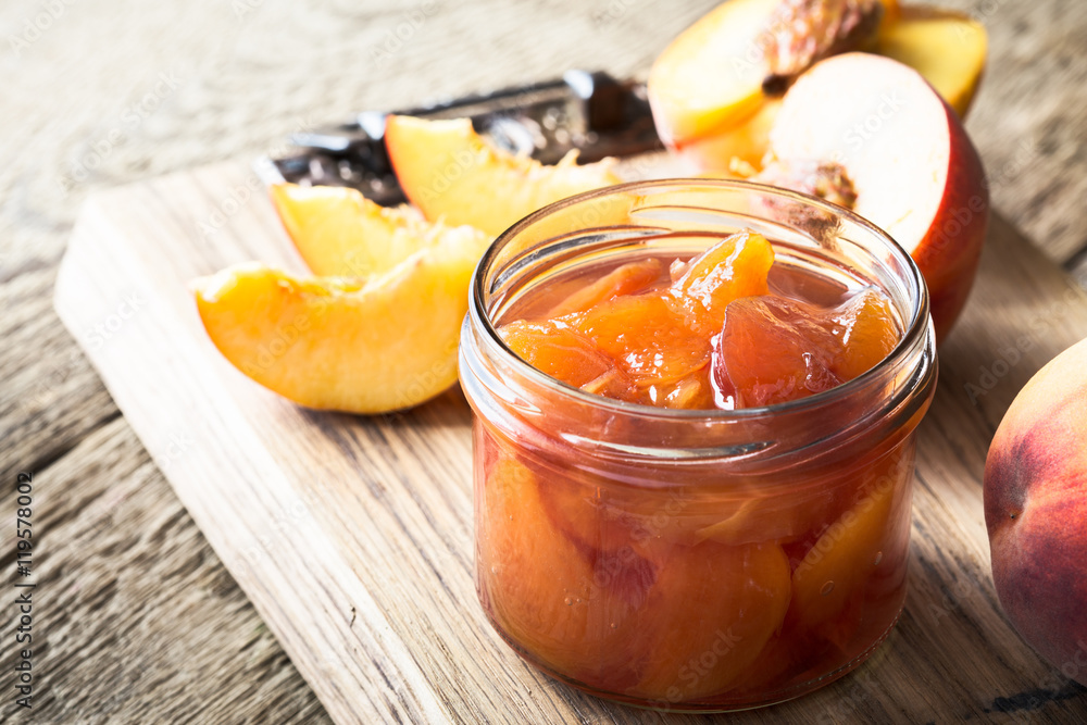 Homemade peach jam on wooden table Homemade peach jam on wooden table