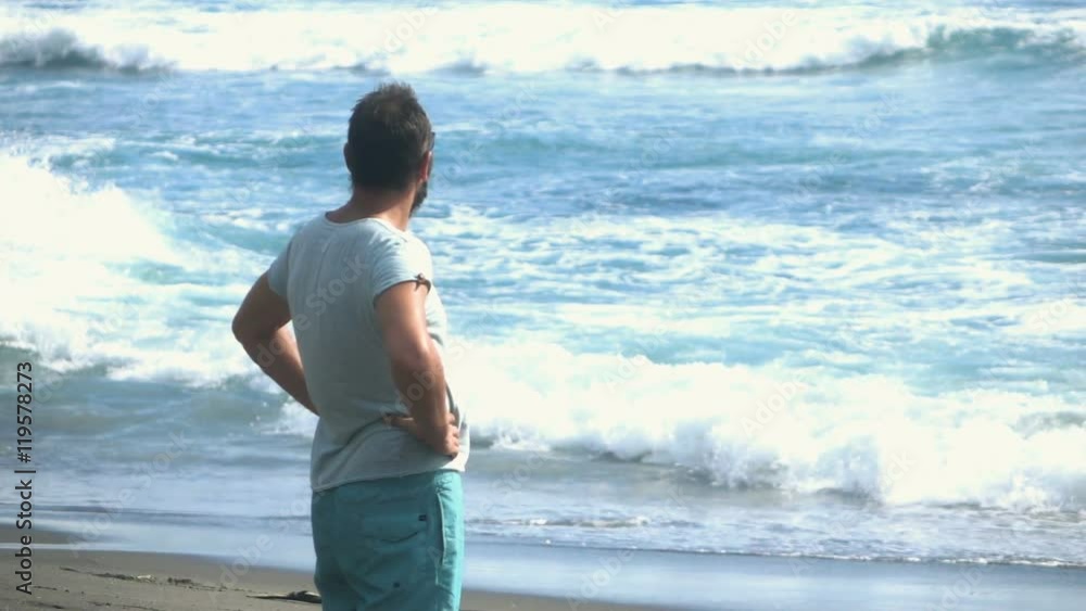 Young man enjoying day standing on beach, super slow motion 240fps
Young man enjoying day standing on beach, super slow motion 240fps