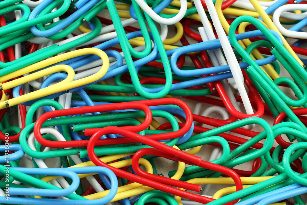 An extreme close up image of colored paper clips An extreme close up image of colored paper clips