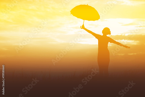 Umbrella woman and sunset silhouette © stcom