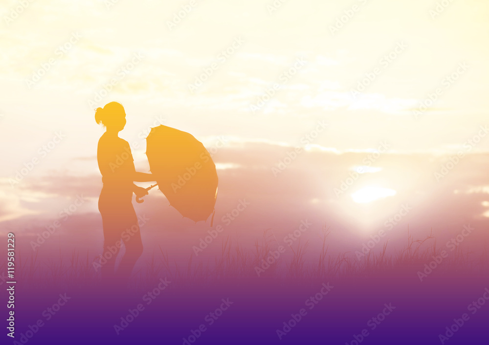 Umbrella woman and sunset silhouette