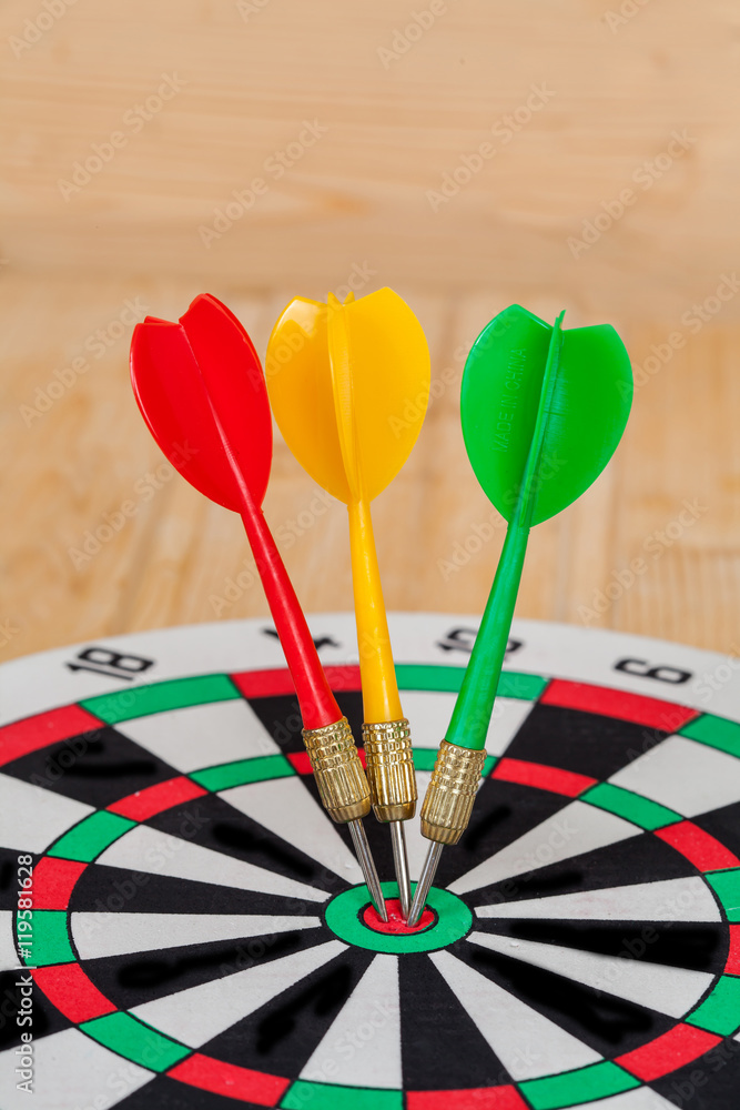 Dart arrow hitting in bullseye on dartboard Dart arrow hitting in bullseye on dartboard