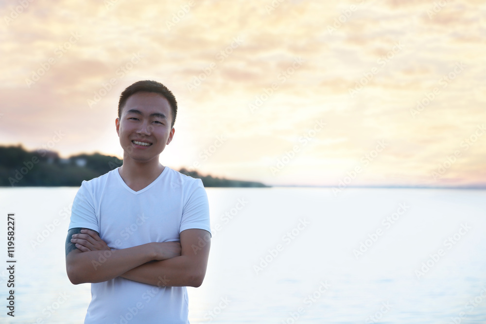 Young handsome boy on river background Young handsome boy on river background