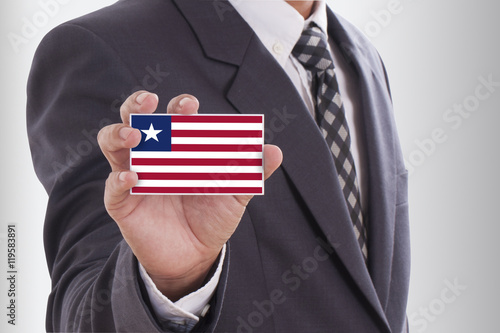 Businessman holding a business card with Liberia Flag
