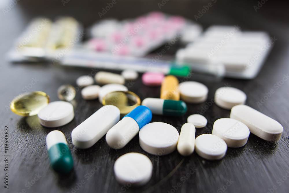 Closeup of pills and thermometer Closeup of pills and thermometer